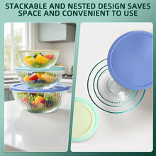 Stacked glass mixing bowls with matching lids for kitchen storage