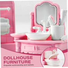 Pink and white dollhouse bathroom vanity with sink, mirror, and accessories.