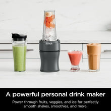 Personal blender with clear jar and multiple to-go cups filled with smoothies
