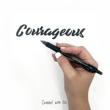 Retractable fine-point gel pen with black ink held in hand