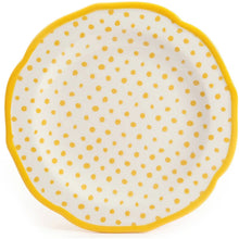 Dinner plate with white surface and small yellow polka dots, bordered by yellow rim