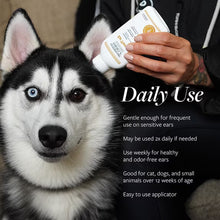 Dog portrait with hand holding ear therapy bottle; daily use text overlay