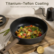 Black nonstick skillet with sautéed vegetables and a lemon on a cutting board nearby