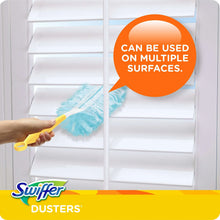 Cleaning duster with blue refill head and yellow handle, dusting white window blinds