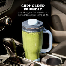 Personal blender travel tumbler with handle, filled with green smoothie, leakproof lid.