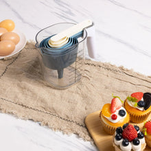 Nested blue stackable measuring cups with measuring pitcher and utensils