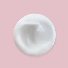 White cream product sample in a round smear, smooth glossy texture