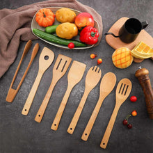 Wooden cooking utensils set with slotted spoon, spatulas, and serving tools