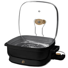 Electric skillet with glass lid, perforated steam rack, and black nonstick base
