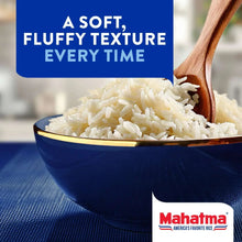 Bowl of basmati rice with wooden spoon and Mahatma branding