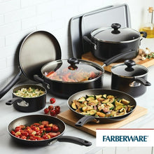 Black nonstick cookware set with frying pans, pots, and griddle on countertop