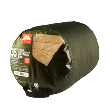 Packed doublewide sleeping bag in green stuff sack with 35F rating label