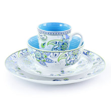 Porcelain stack with blue and green floral rims bowls, cup, and saucer