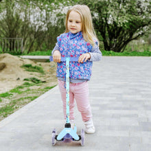 Toddler riding a 3-wheel light-up scooter with a blue patterned stem and deck