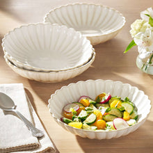 Cream stoneware dinner bowls with scalloped ridges, set of 4, one filled with salad