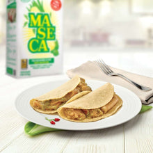 Corn masa tortillas folded on plate with fork and knife