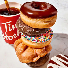 Decaf ground coffee and donut stack with Tim Hortons branded cup