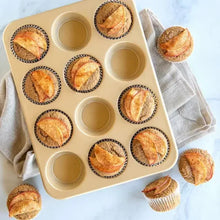 Natural aluminum loaf pan with round cavities holding baked mini loaves