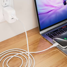 White braided USB-C charging cable connected to a wall charger and a laptop