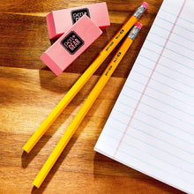 Yellow sharpened #2 wood pencils and pink eraser blocks on a desk