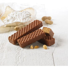 Chocolate-coated peanut butter waffle snack bars with crumbs on a light surface