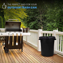 Black trash bag liner inside an outdoor trash can