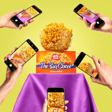 Microwave popcorn box with several smartphones held above the box