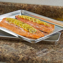 Half-size aluminum sheet pan with two slices of baked salmon