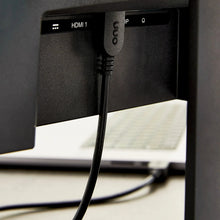 HDMI cable plugged into TV port, black connector and cable