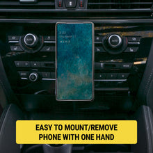 Black MagSafe CD-slot phone mount holding a smartphone in a car center console
