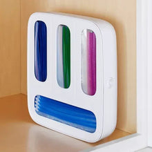 White food bag dispenser with blue, green, and pink bag rolls in front slots