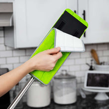 Flat mop microfiber pad held in hand over wringing head