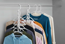 White cascading clothing hangers with multiple hooks holding shirts on a rack