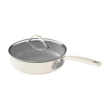 Cream dutch oven with gray interior and glass lid
