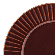 Close-up of glossy red stoneware rim with ribbed fan pattern