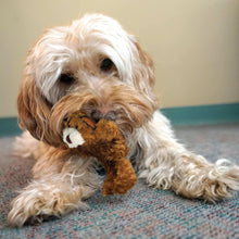 Small white-and-brown plush teddy bear toy, lying down with front paws forward