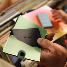 Bluetooth wallet tracker card with chipolo logo, attached to light green leather card case