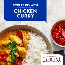 Plate of white rice with chicken curry and red pepper slices