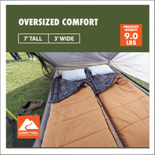 Tan cold-weather sleeping bag laid open with quilted panels at the foot end