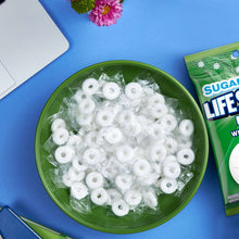 Sugar-free mint hard candies in a bowl with Wint-O-Green packaging shown