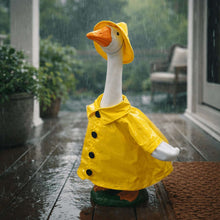 Goose statue wearing a yellow raincoat with white wing sleeves.