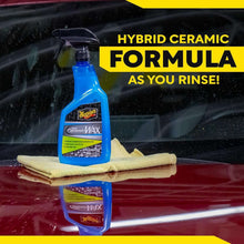 Meguiar's Hybrid Ceramic Wax spray bottle with microfiber cloth on car hood