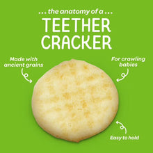 Round, pale golden teether cracker with a lightly textured surface.