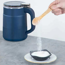 Blue electric spice grinder dispensing powder onto a small dish on a countertop