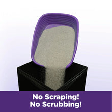 Clumping cat litter scoop with pale beige litter in a purple tray.