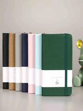 Green A7 pocket notebook with hard cover and wide elastic closure strap