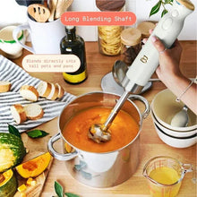 Cordless immersion blender in white icing with long blending shaft in a pot