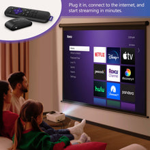 Mini projector projecting streaming menu with Roku remote and streaming player