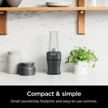 Personal blender with clear blending jar and two to-go cups on countertop