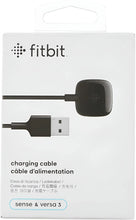 Fitbit charging cable package with black charging puck and USB connectors.